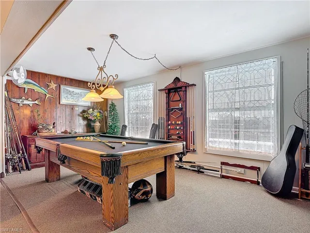 Playroom with pool table, carpet floors, and wooden walls