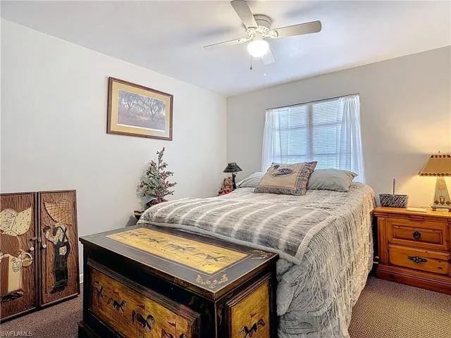 Bedroom featuring a ceiling fan and carpet flooring