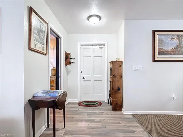 Foyer entrance with baseboards and wood finished floors