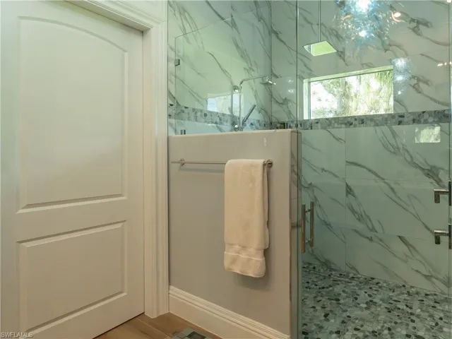 Bathroom featuring a marble finish shower