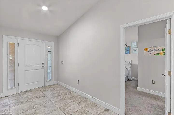Foyer entrance with baseboards