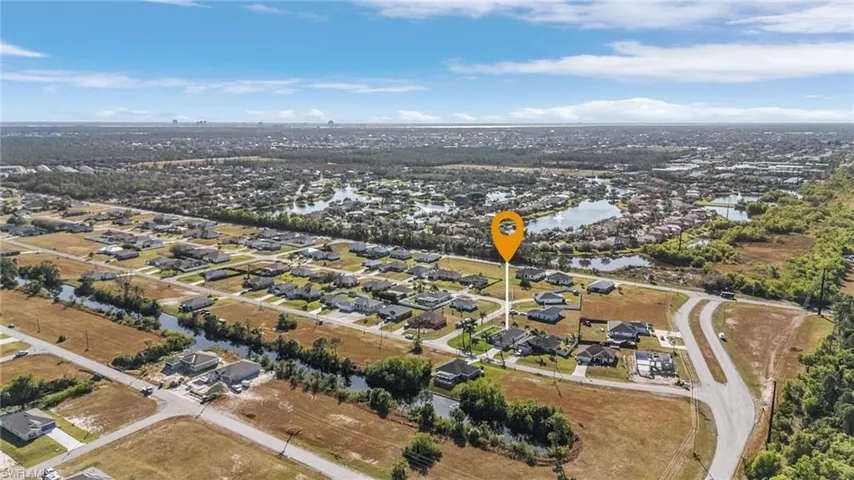 View of property location featuring nearby suburban area and a nearby body of water