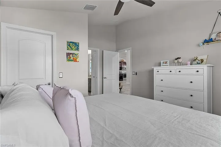 Bedroom with vaulted ceiling and ceiling fan