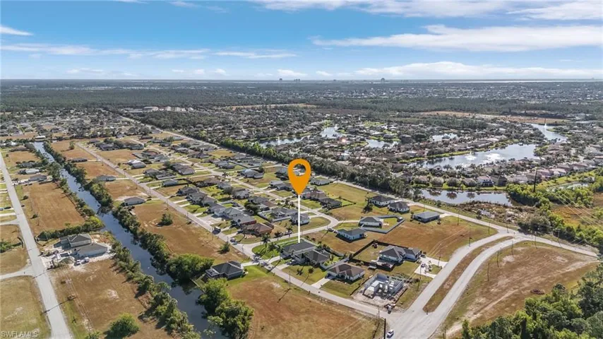 Aerial overview of property's location featuring nearby suburban area and a nearby body of water