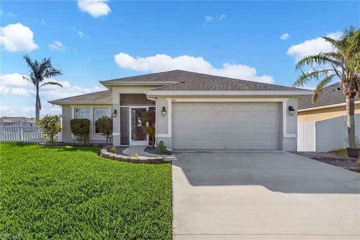 Single story home featuring stucco siding, driveway, a garage, and roof with shingles