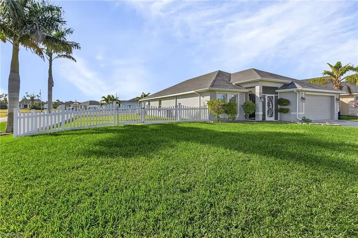 View of yard with a garage and driveway