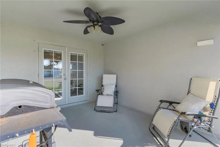 View of patio featuring french doors, a ceiling fan, and a grill
