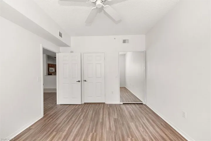 Neutral white walls with wood-finish flooring