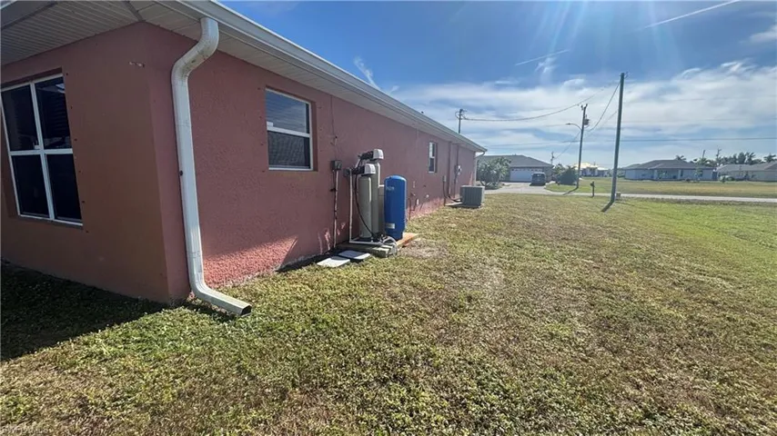 View of home's exterior with a yard