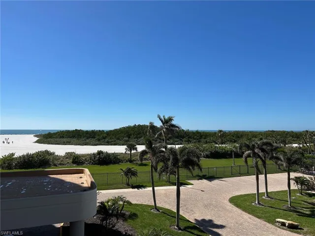 View of home's community with a water view and a lawn
