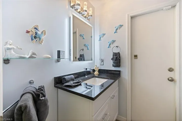 Bathroom featuring vanity and a chandelier