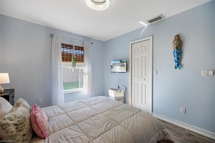 Bedroom featuring wood finished floors and a closet