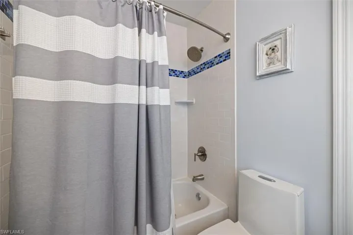 Bathroom with shower / bath combo and toilet