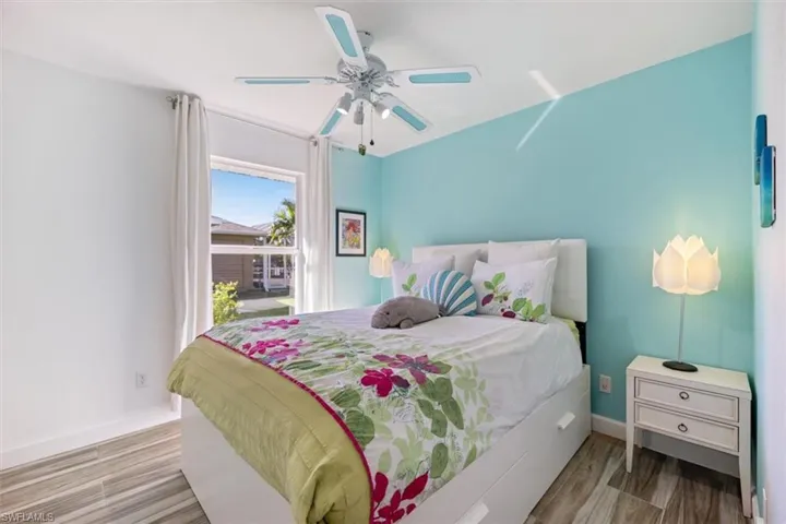 Bedroom featuring wood finished floors and a ceiling fan