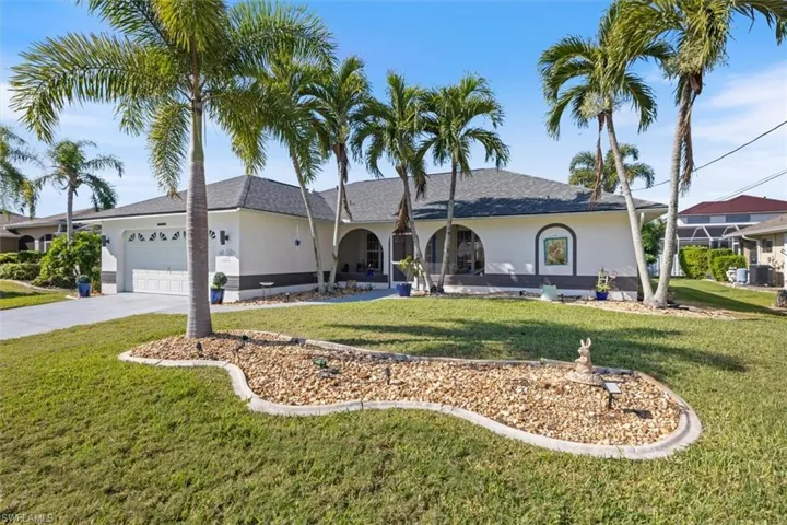 Ranch-style house with stucco siding, roof with shingles, a front lawn, and an attached garage