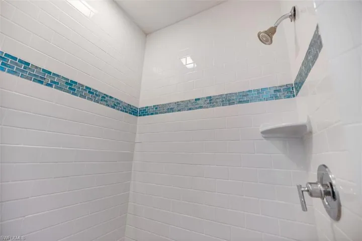 Bathroom view of a tile shower