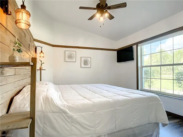 Bedroom featuring lofted ceiling and a ceiling fan
