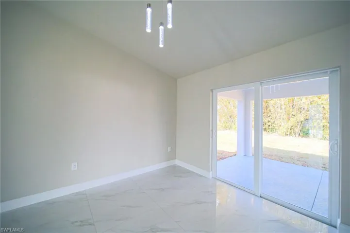 The Large Dining Area Has Modern Lighting, Canal View, And Dual Sliders That Lead Out To A Covered Lanai!