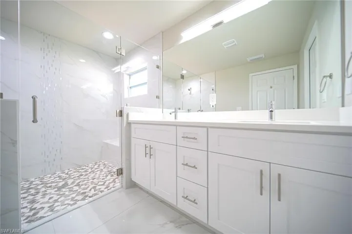 The Master Bathroom Has A Glass Enclosed Shower With Custom Tile Inlays And Seating Area, Quartz Countertops, Soft Touch Cabinet Drawers And Doors, And Brushed Nickle Finishes!