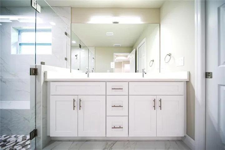 The Master Bathroom Has A Glass Enclosed Shower With Custom Tile Inlays And Seating Area, Quartz Countertops, Soft Touch Cabinet Drawers And Doors, And Brushed Nickle Finishes!