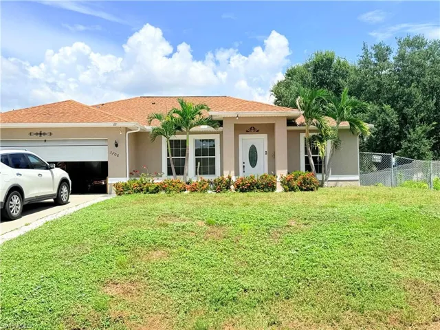 Stucco exterior with a shingle roof, attached garage, and a concrete driveway