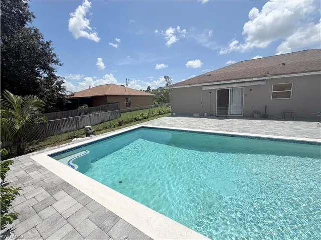 Rectangular swimming pool with integrated steps, surrounded by paver decking