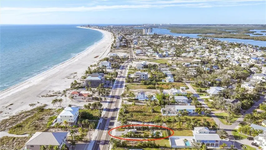 Aerial perspective of suburban area featuring waterfront with a beach