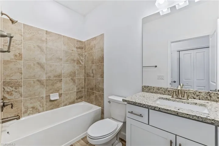Bathroom with shower / washtub combination and vanity