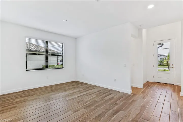 Spare room with light wood finished floors and recessed lighting