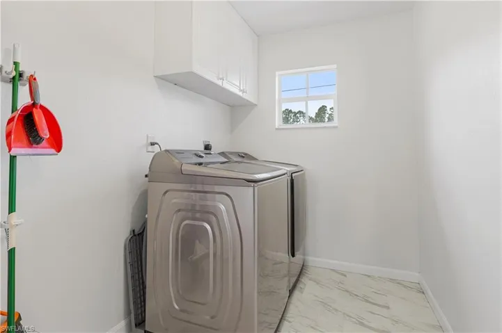 Inside laundry room with washer & dryer