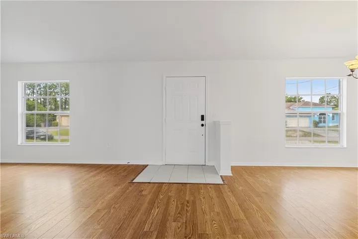 Entrance foyer with light hardwood / wood-style flooring