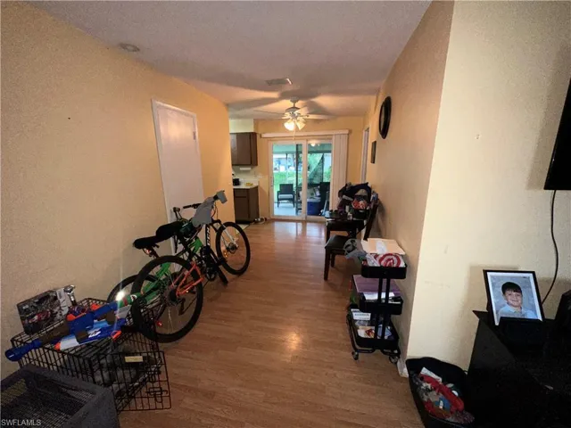 Hall with light hardwood / wood-style flooring