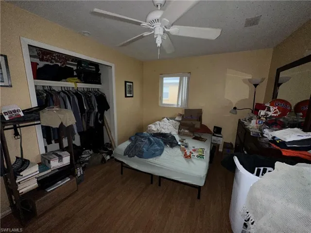 Bedroom with a closet, ceiling fan, and hardwood / wood-style flooring