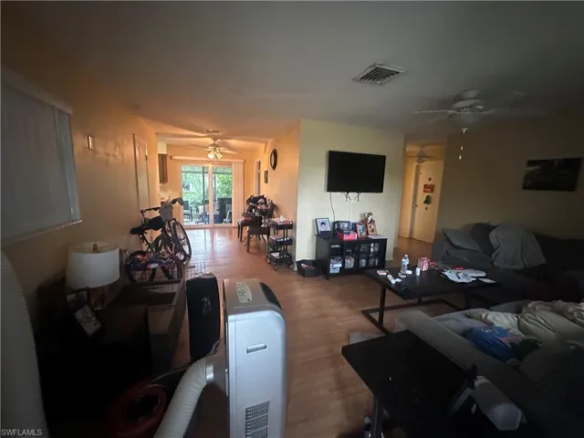 Living room featuring ceiling fan and hardwood / wood-style flooring