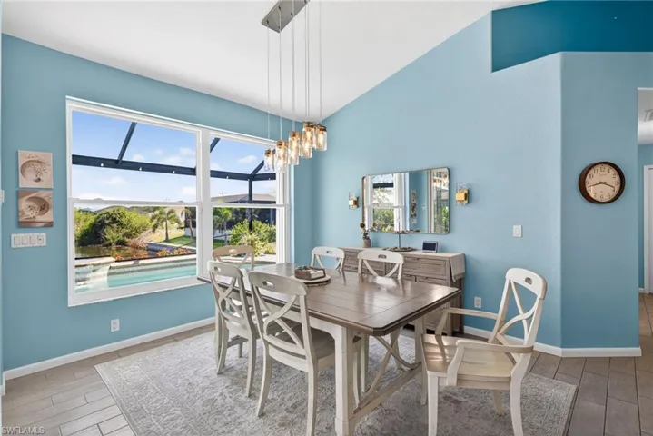 Spacious interior with high vaulted ceilings and a large window overlooking a screened pool area