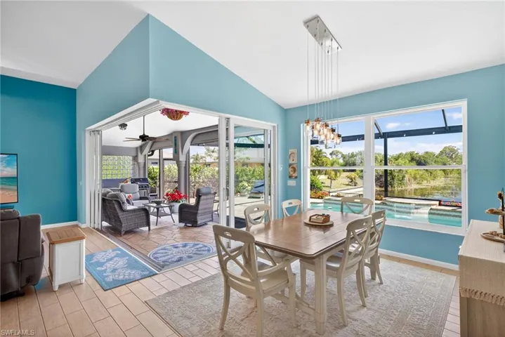 Vaulted ceilings, sliding glass doors, built-in lighting, and expansive windows