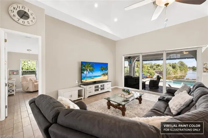 Vaulted ceiling, recessed lighting, wood-finish flooring, sliding glass doors, and a ceiling fan