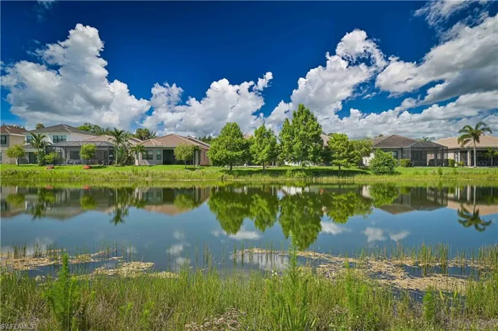 Lakefront properties featuring screened outdoor living areas, mature landscaping, and private backyards