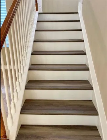 Staircase featuring wood finished floors