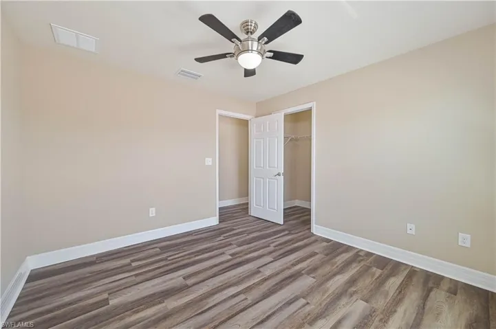 Neutral tone walls with wood-finish flooring