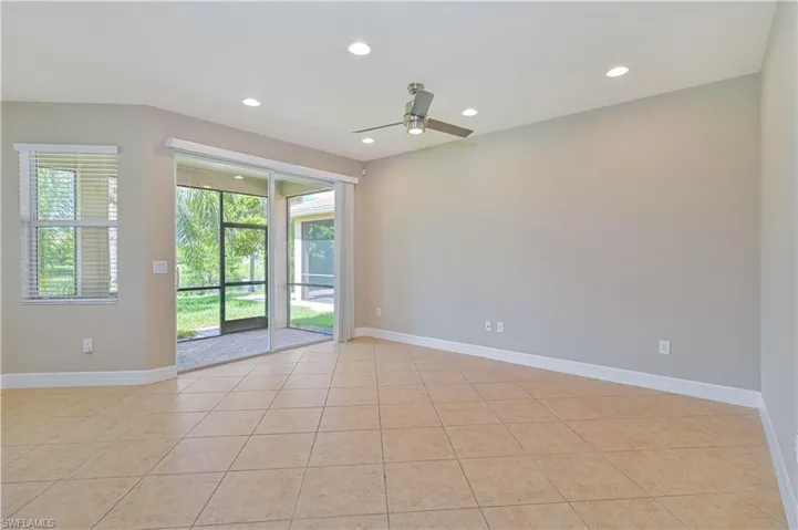 Spacious interior room featuring diagonal tile flooring and light neutral wall tones