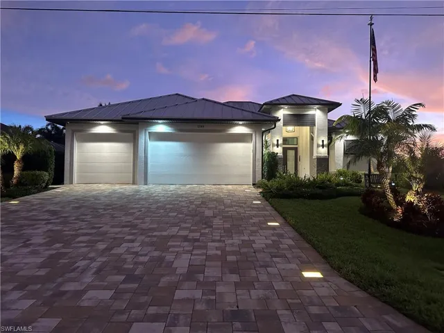 Front of the house at sunset with paver and landscaping lights