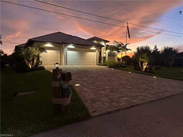 House at sunset with paver and landscaping lights