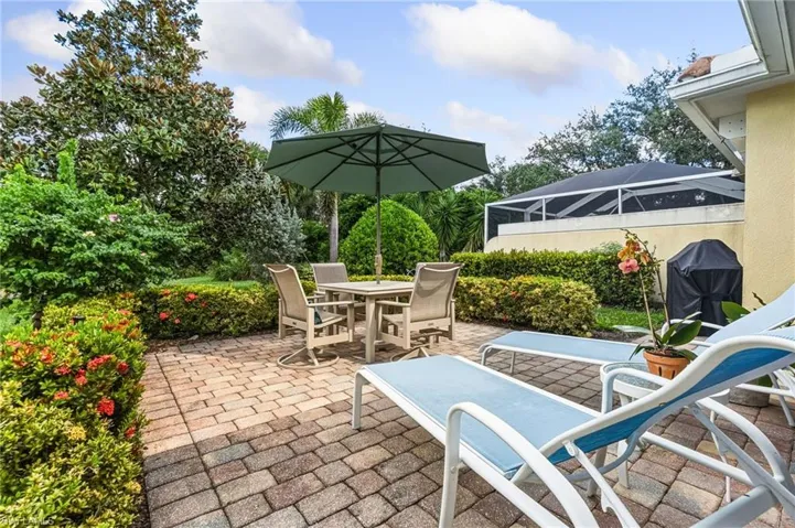 View of patio / terrace featuring glass enclosure, a sunroom, outdoor dining space, and grilling area