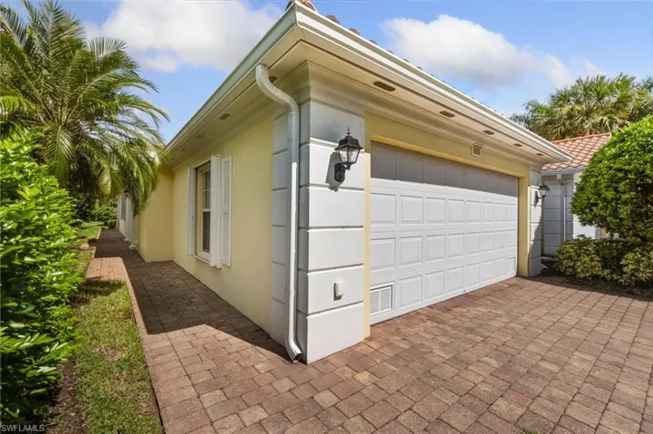 View of side of home featuring a garage and stucco siding