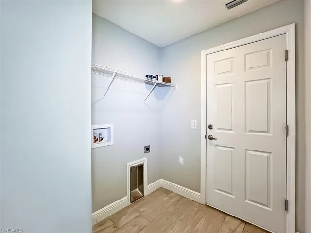 Washroom featuring electric dryer hookup, washer hookup, and light hardwood / wood-style floors
