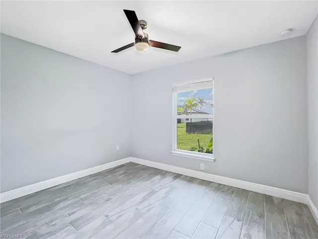 Spare room featuring hardwood / wood-style flooring and ceiling fan