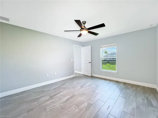Spare room featuring light wood-type flooring and ceiling fan