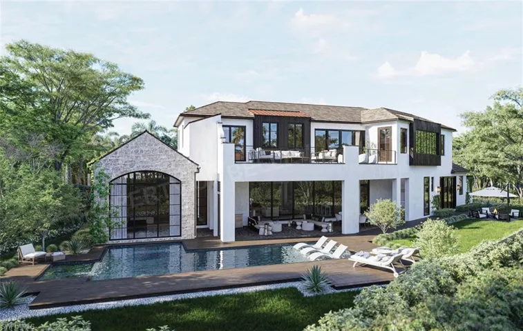 Back of property with a balcony and a patio