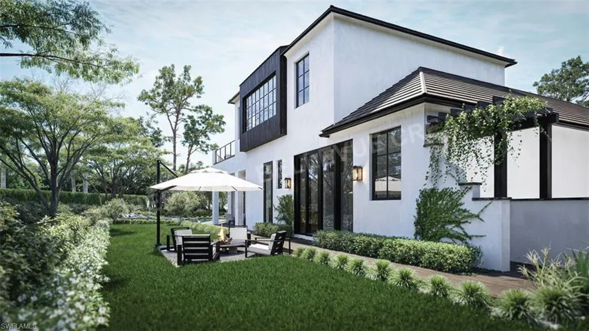 Rear view of house featuring an outdoor hangout area and a yard